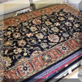 R107. Hand tufted wool rug.